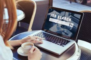 careers professional searching for jobs on laptop
